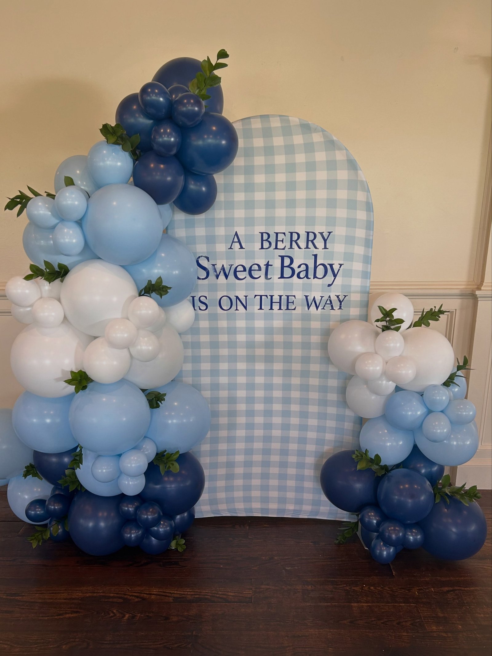 Blue and white baby shower balloon arch